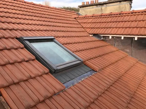 Descente d'eaux pluviales en zinc le long d'une façade, à Bièvres